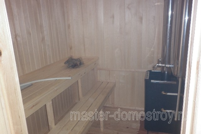 Парное помещение деревянной бани. Двухъярусные пологи из осиновой доски. Печь Ермак с баком на 65 литров.